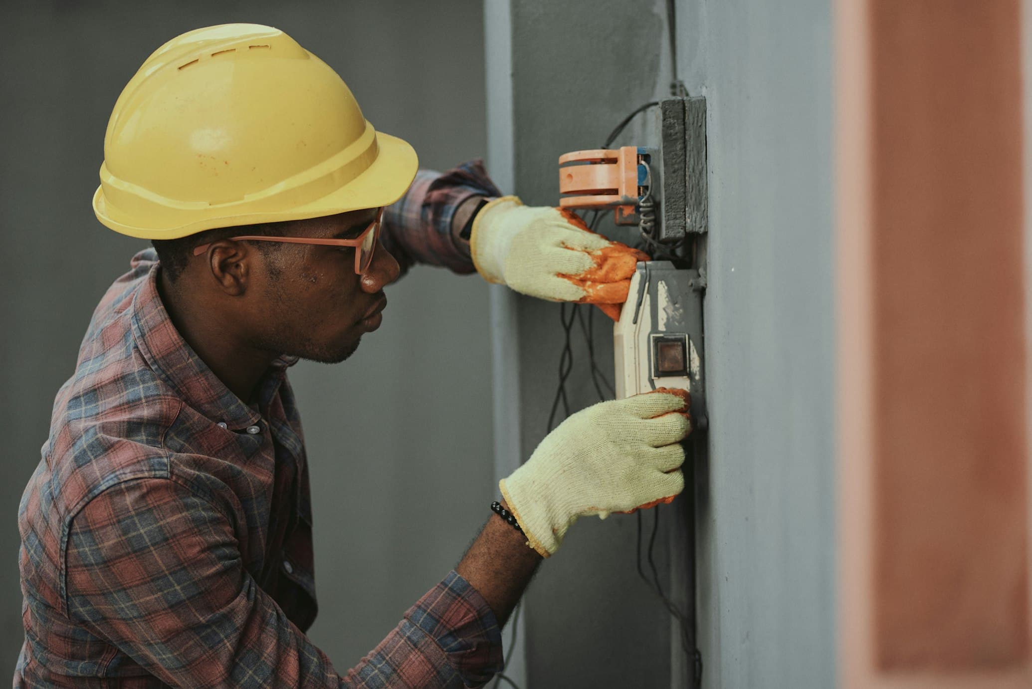 Licensed electrician performing electrical panel upgrade in Ottawa, showing modern safety equipment and professional installation